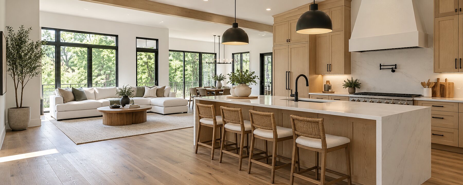 Bright remodeled kitchen and living area with warm wood cabinetry and black accents